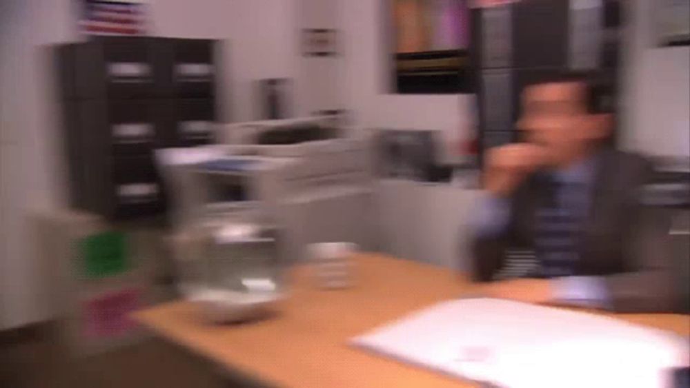 a blurry image of a man sitting at a desk