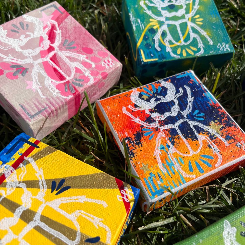 Closeup of the stag beetle paintings lying in the grass 