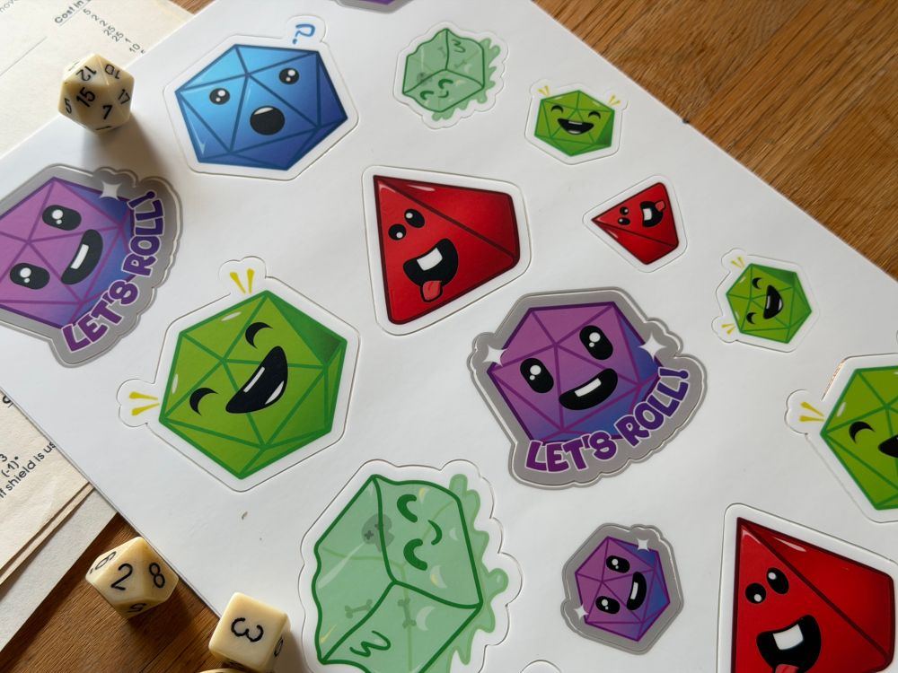 Silly looking D&D dice stickers in a sticker sheet - they have silly faces. 