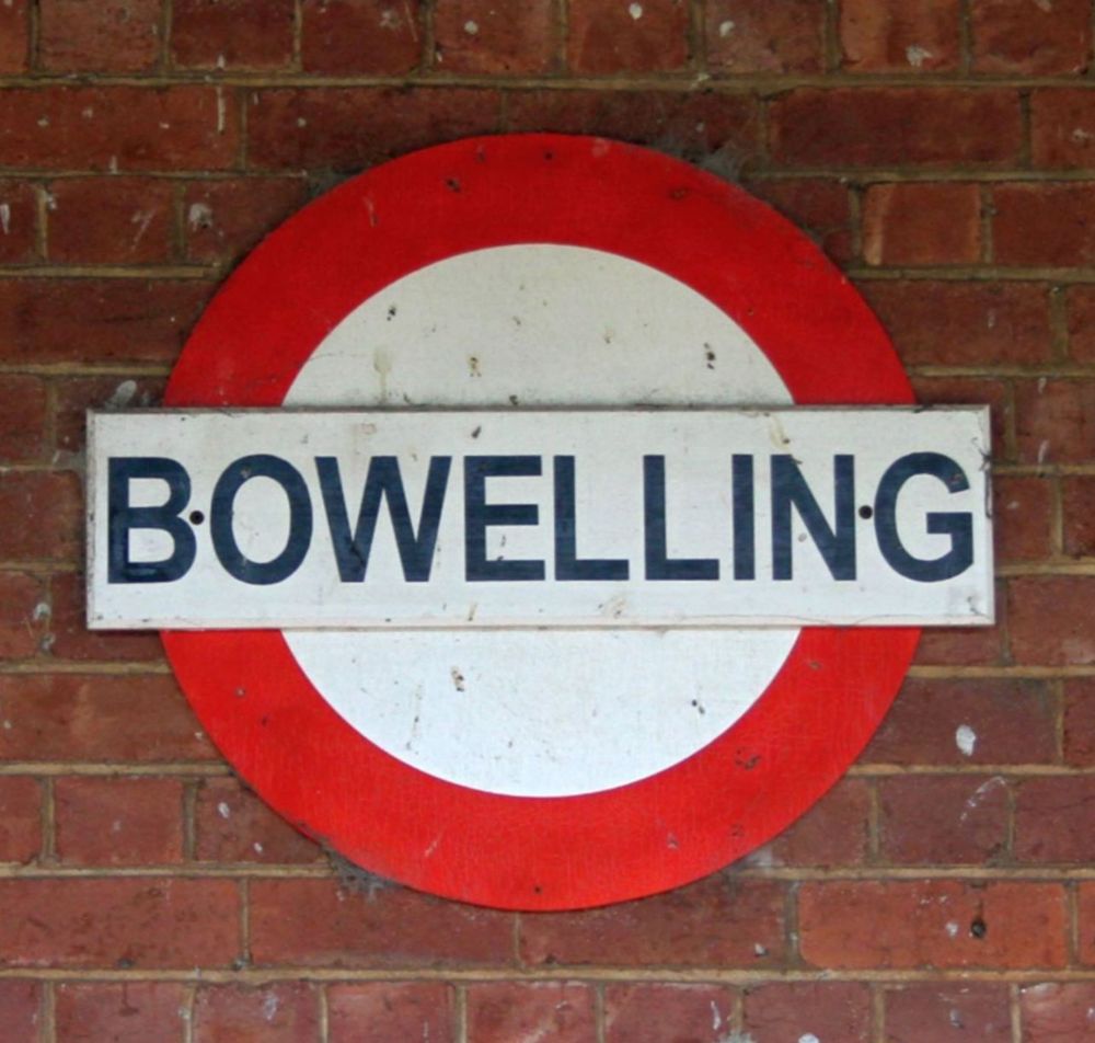 A train station sign for the town of Bowelling, presumably. 