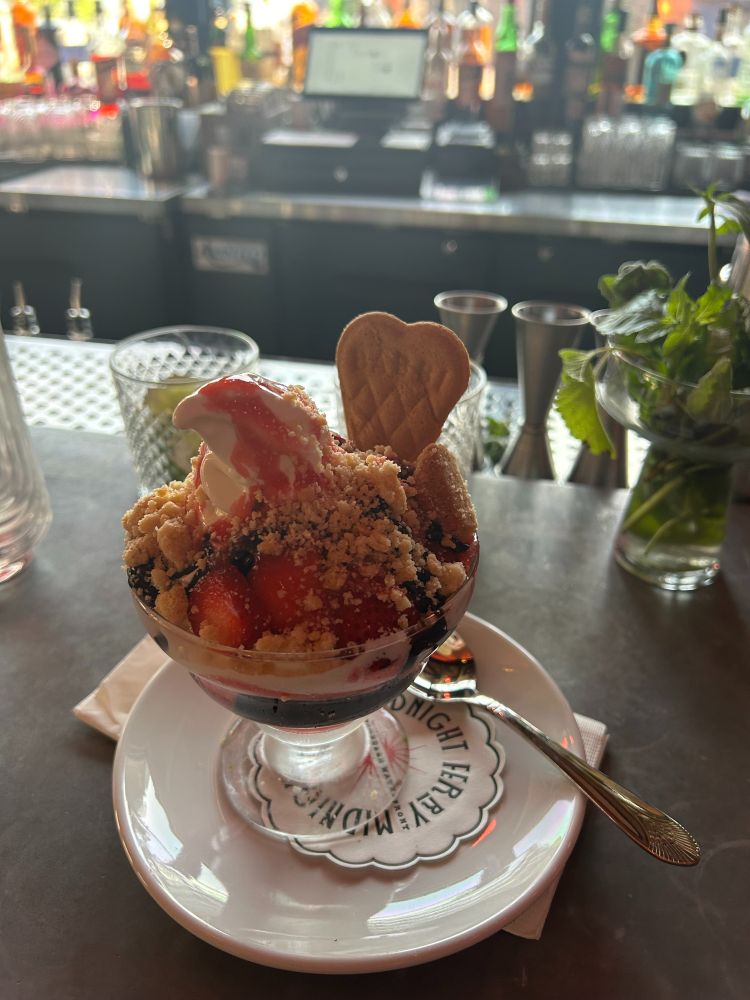 Ice cream sundae with vanilla ice cream, strawberries and hot fudge. 