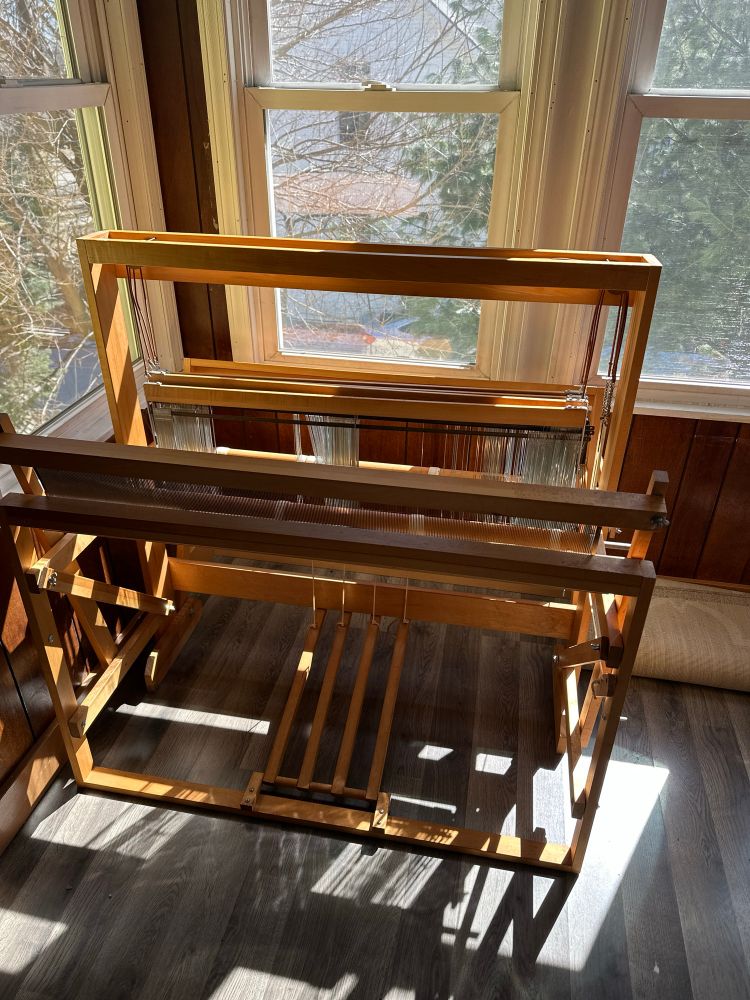 A 4 shaft 36” Harrisville floor loom basking in a sunny corner of a windowed room