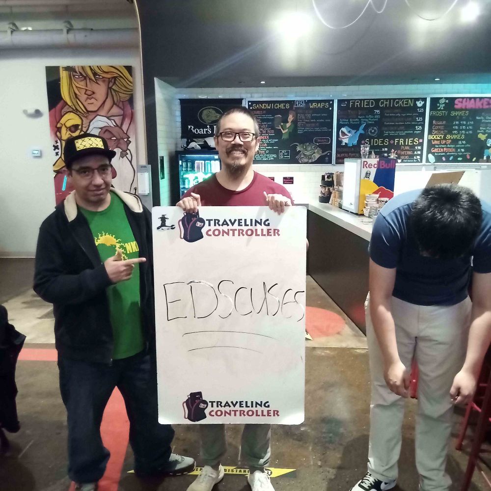 Top 3 picture. Ding looks dejected. Earnest holds a whiteboard that reads "EDSCUSES"