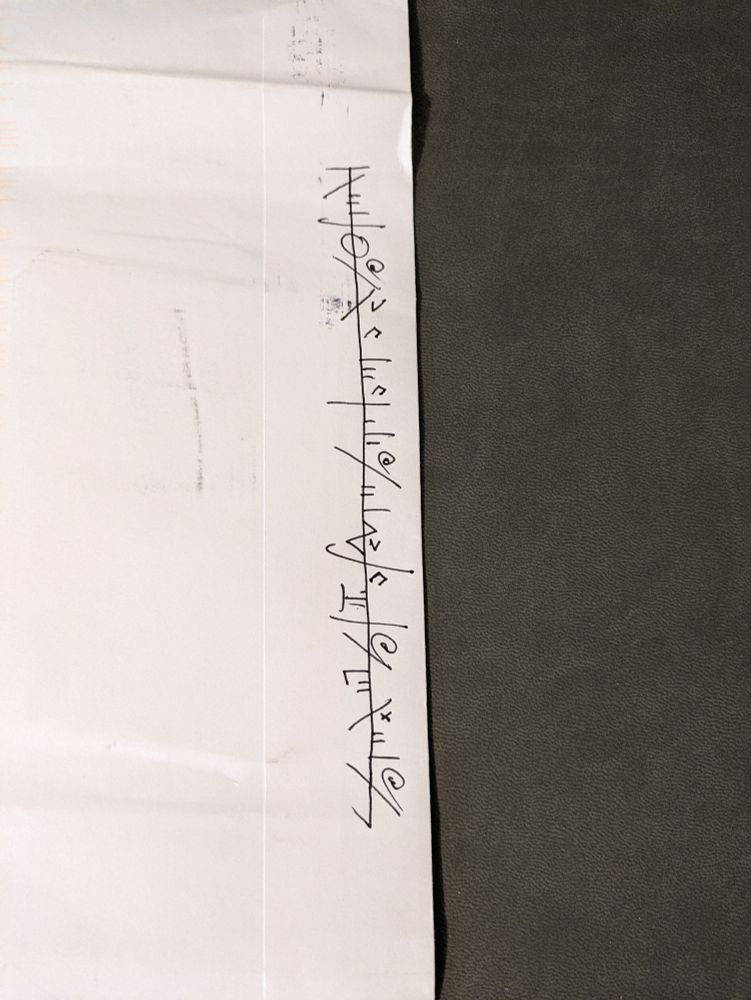 An envelope with a message written in the Phyrexian language from the game Magic: The Gathering.