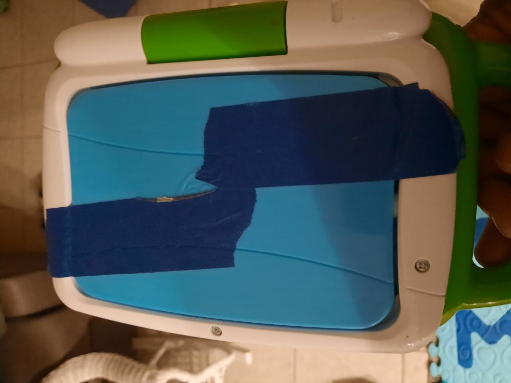 A leapfrog 2-in-1 tablet computer for toddlers with blue masking tape stopping it from going into tablet mode