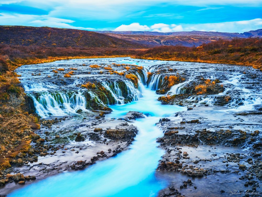 The beautiful blue water of Bruarfoss flowing   over the rocky edges and on downstream, all captured by a long exposure.