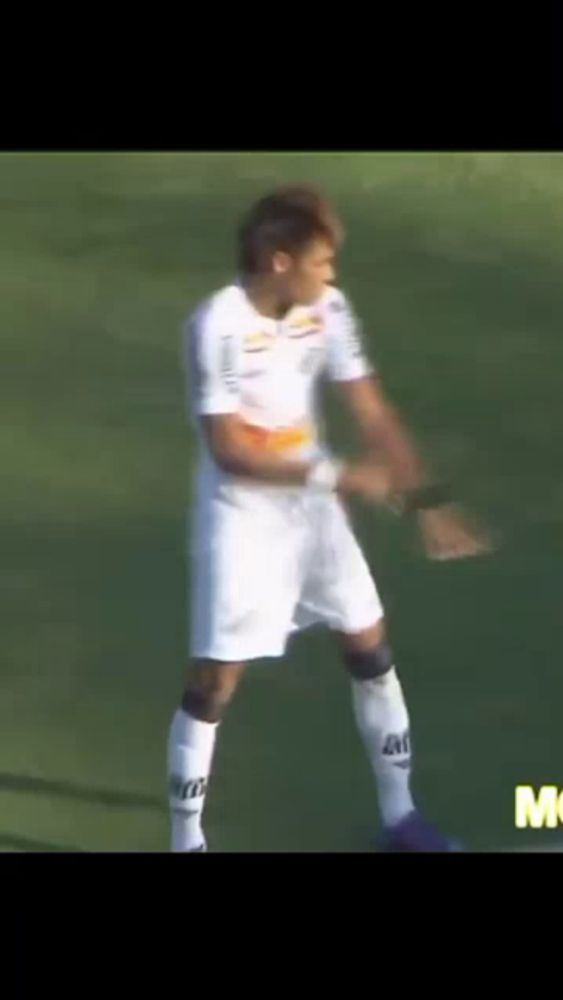 a man in a white soccer uniform is standing on a soccer field