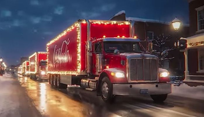 An AI generated truck, part of Coca Cola's 1-minute AI-generated commercial which took 30 days and 70,000 prompts to create. The truck is fine, except that it's missing wheels and has some kind of tank attached to the passenger door, and also looks different from the other trucks in different scenes.