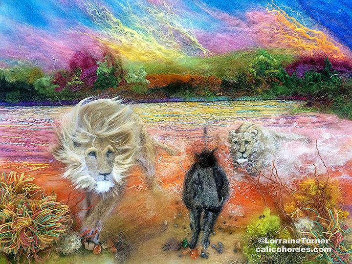 A textile illustration of two white and tan lions chasing a gray and black warthog. Sky is blue, pink, yellow and gold and is reflected on the water with green, gold, maroon and tan foreground 