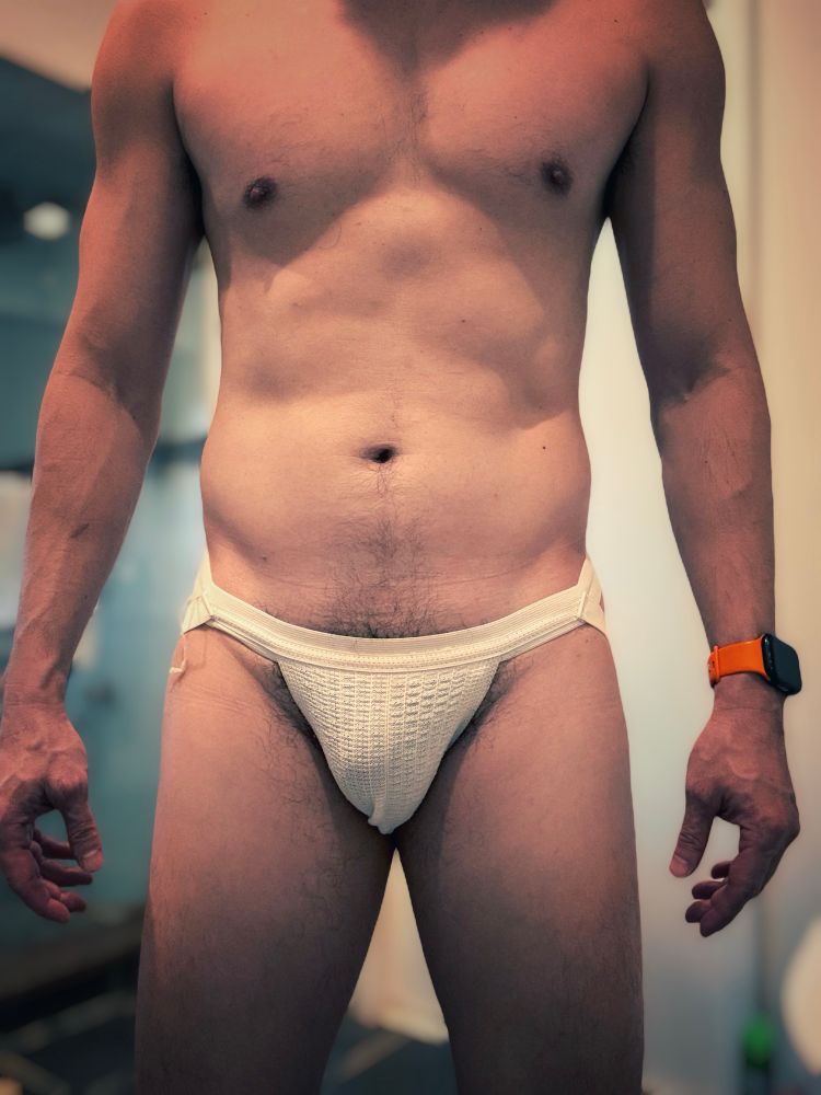 Front view of guy wearing white jockstrap