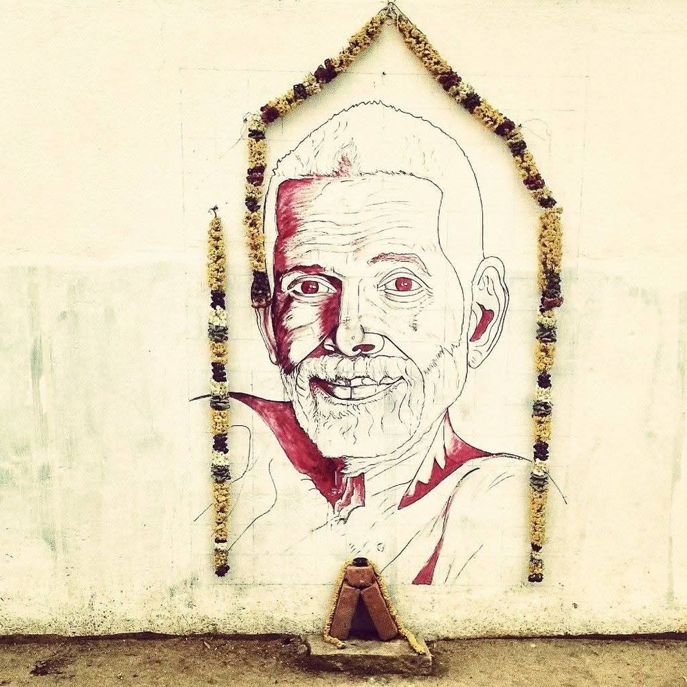 A garlanded line-drawing mural of Sri Ramana Maharshi (1879-1950) on the rear wall of Sri Ramanasramam, Chengam Road, Tiruvannamalai, Tamil Nadu, India. There is a small platform beneath it on which to light a diya, candle or incense.

Carl Jung wrote:

“Sri Ramana Maharshi is a true son of the Indian Earth. He is genuine, authentic and, in addition to that, something quite phenomenal. In India, he is the whitest spot in a white space. What we find in the life and teachings of Sri Ramana is the purest of Bharat [India] with its breath liberating humanity. The life and teachings of Sri Ramana are not only important for India, but also for Westerners."