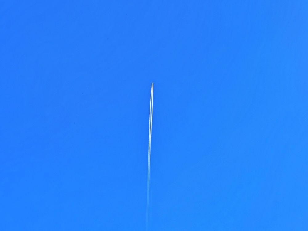  A thin strip of white across an otherwise blue sky. A contrail is a line-shaped cloud, also known as condensation trail, formed by the exhaust from aircraft engines at high altitude. 

It consists primarily of water in the form of ice crystals, which form when the hot, moist exhaust from the engine mixes with the extremely cold air of the upper atmosphere. 

The visibility and persistence of the contrail depends on the temperature and humidity of the surrounding air; in very dry air, it may quickly dissipate, while in humid conditions, it can spread and persist for hours, sometimes forming large, cirrus clouds.