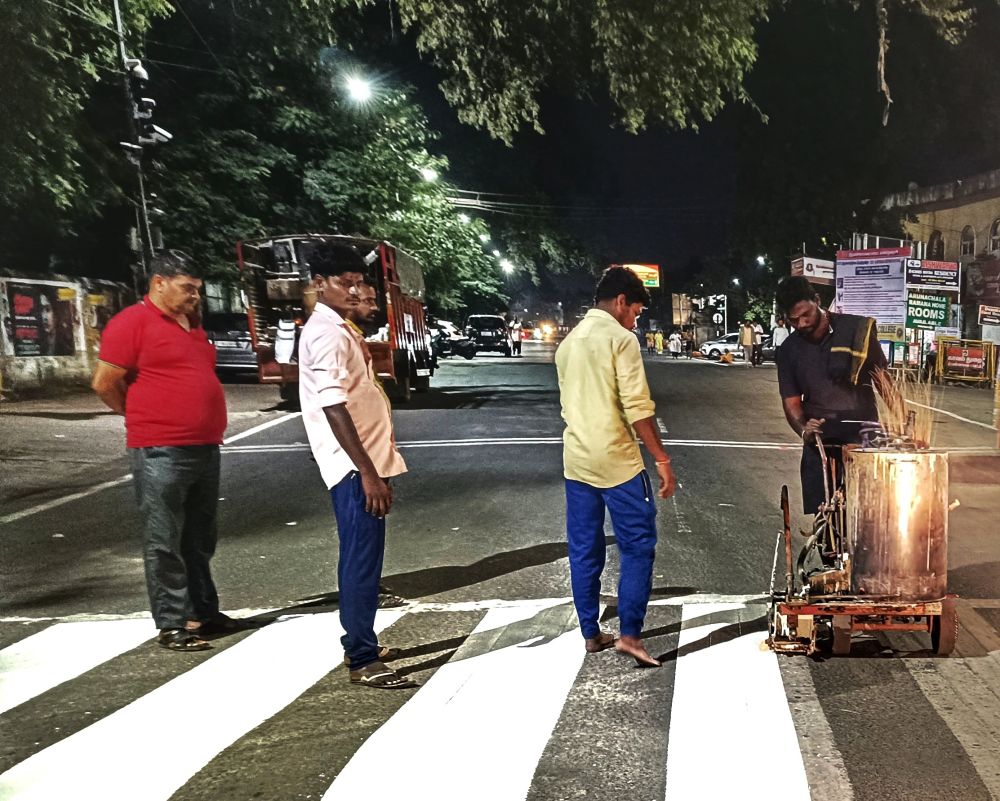 It's nighttime and there is relatively little traffic on the road. Four Indian men stand on a crosswalk and look on as a fifth manually operates a specialised machine applying white durable thermoplastic paint for road markings. This is being heated to a high temperature and carefully spread on by the steersman as a hot melt.

The lyrics come from Johnny Cash's first number-one hit which remained on the American charts for over 43 weeks. Bob Dylan described it as "... a song I'd always considered to be up there at the top, one of the most mysterious and revolutionary of all time, a song that makes an attack on your most vulnerable spots, sharp words from a master."

Chengam Road, Tiruvannamalai, Tamil Nadu, India.