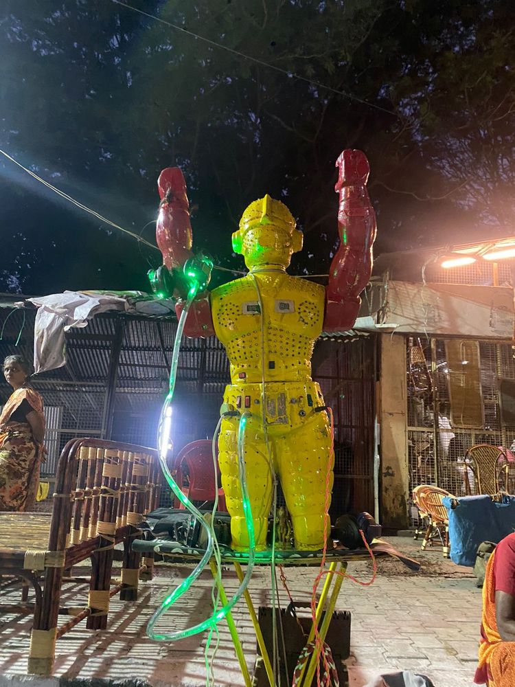 Yellow electronic machine with a green luminescent wire.