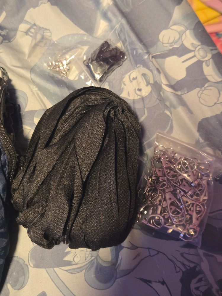 A roll of black zippers and a bag of those Keychain claw clasp thingies