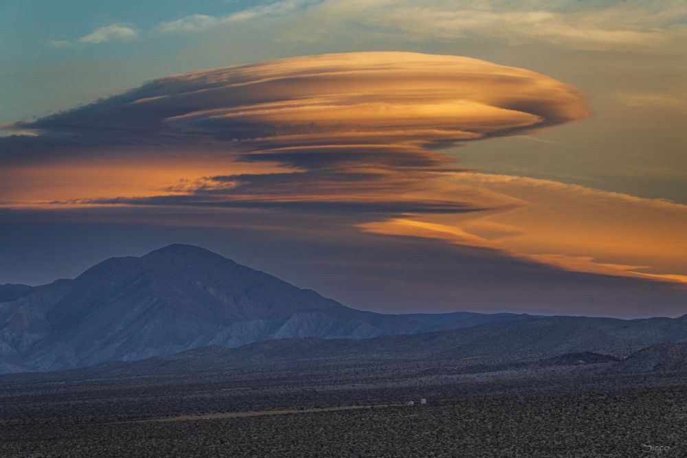 The lenticular clouds stacked above Sunset Mountain