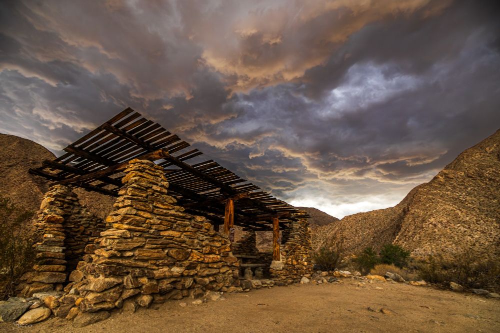 View of one of the stone shade ramadas at Borrego Palm Canyon Campground last week. A dark cloud formation overhead. 
