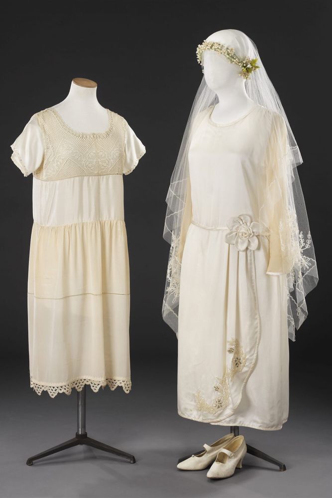 Mid 1920s wedding outfit. On the left, crêpe de chine underdress, on the right fashionable contemporary cream satin wedding dress with matching veil, headdress & shoes, JB