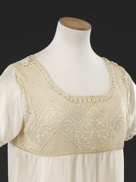 Close in view of 1920s cream wedding underdress or petticoat, showing crocheted cotton yoke, JB