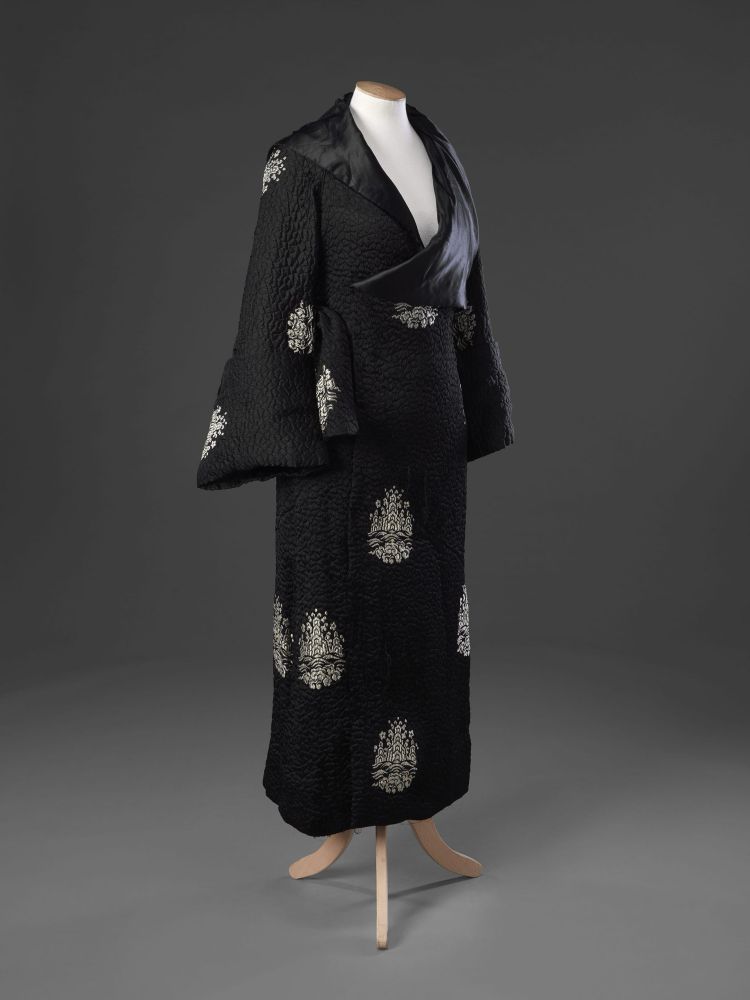 Front/side view of Paul Poiret coat. c1921. The silk fabric has an overall quilted effect to its weave, is scattered with medallions in lustrous thread, JB
