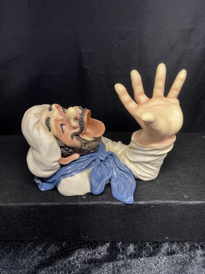 what looks like one of the rapists from the pirates of the carribbean ride cups his hand and opens his mouth ready to receive 