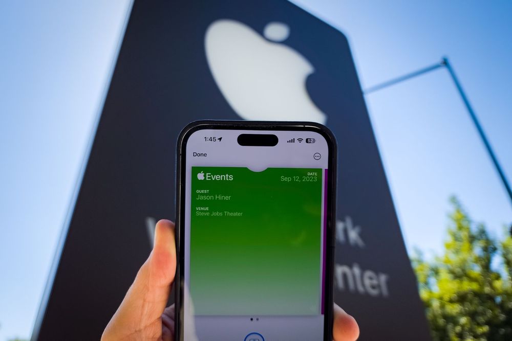 Digital pass to Sep 12, 2023 Apple Event in front of Apple sign at Apple Park.