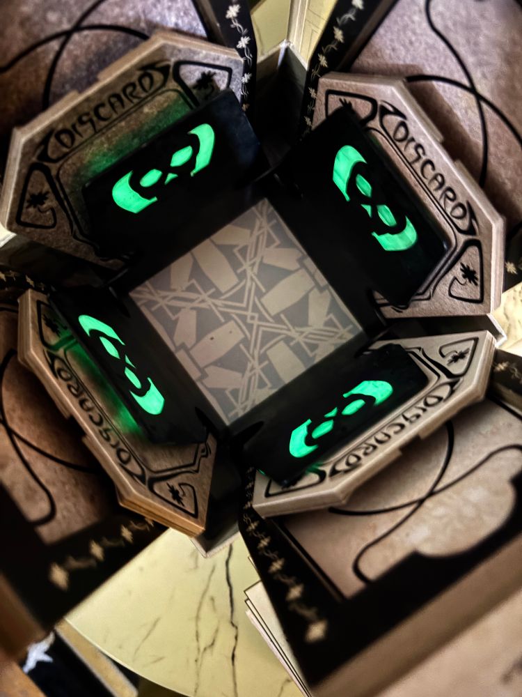 Overhead view of Sepulchre — A Grave Game with customized glow in the dark insert