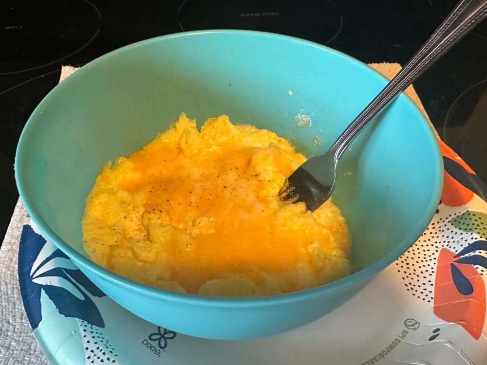 Cheesy scrambled eggs in a bowl.