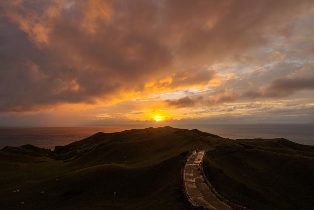 Sunset over rolling hills after rain