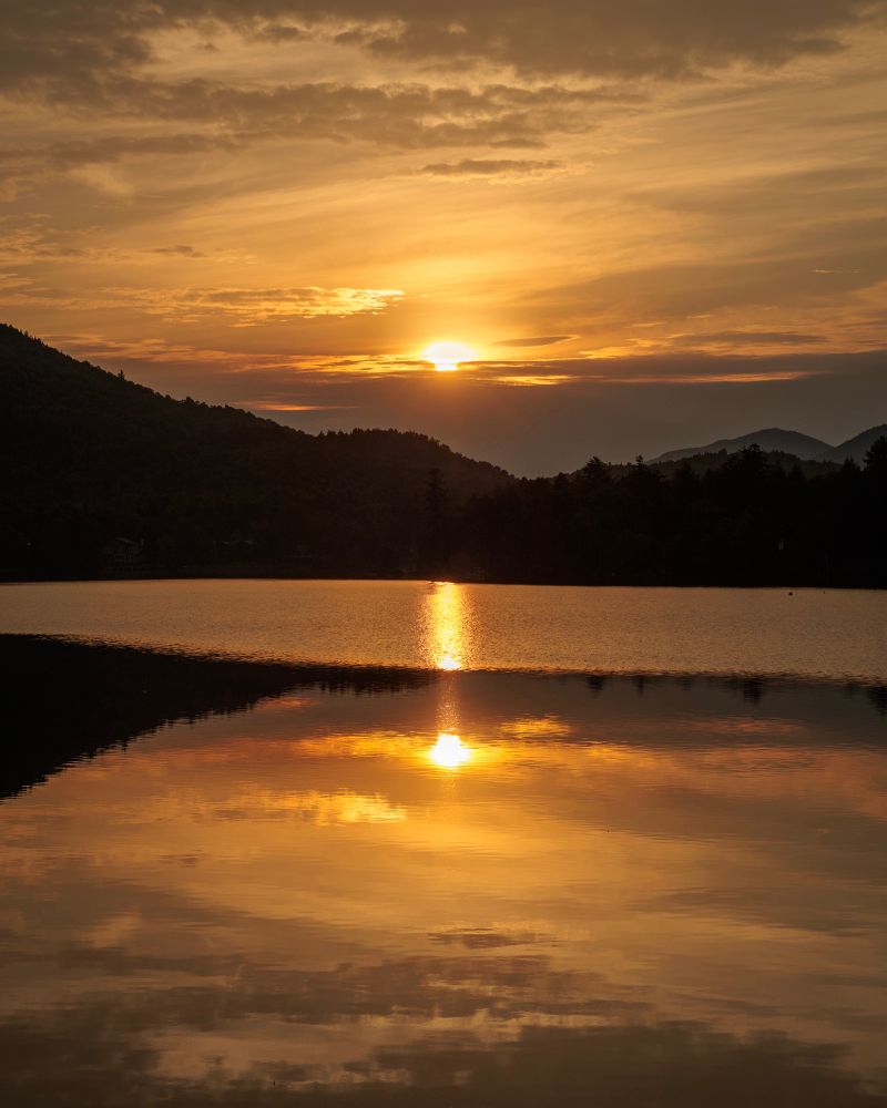 A low sun reflected on a lake.