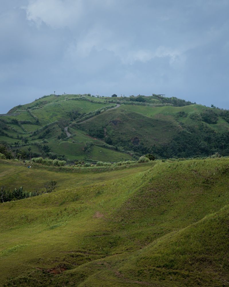A house atop a hill landscape. 