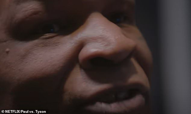 Screen grab from Netflix promo showing Mike Tyson watching Jake Paul on TV call him out. Mike turns to the camera from the couch and delivers the quote. 