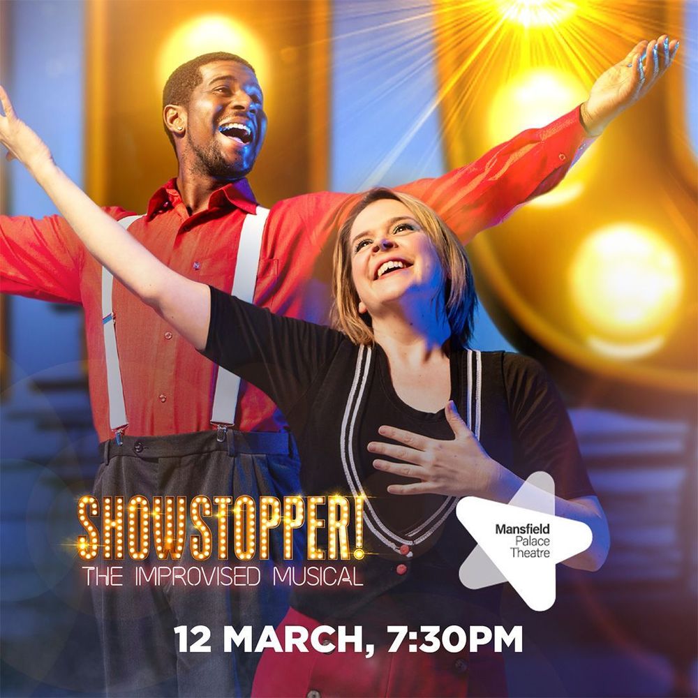 Ruth and Joshua in front of the Showstopper! sign, text says: 'Showstopper! The Improvised Musical. Mansfield Palace Theatre. 12 March, 7:30pm.'
