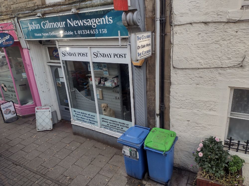 Slightly squint photo of John Gilmour Newsagents in Cupar, a wee shop in a wee old stone building. The main 
