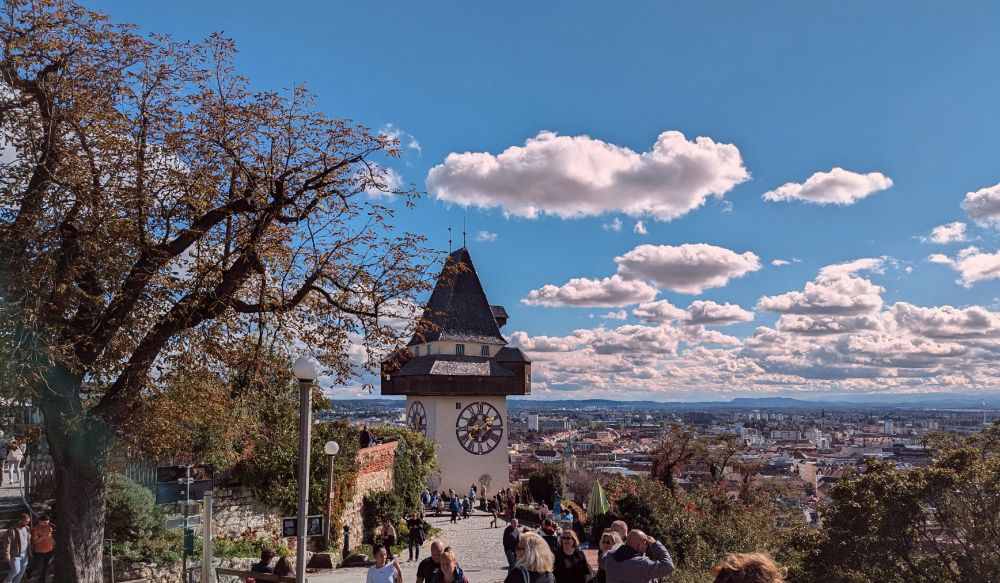The clock tower of Graz and the city in the background.