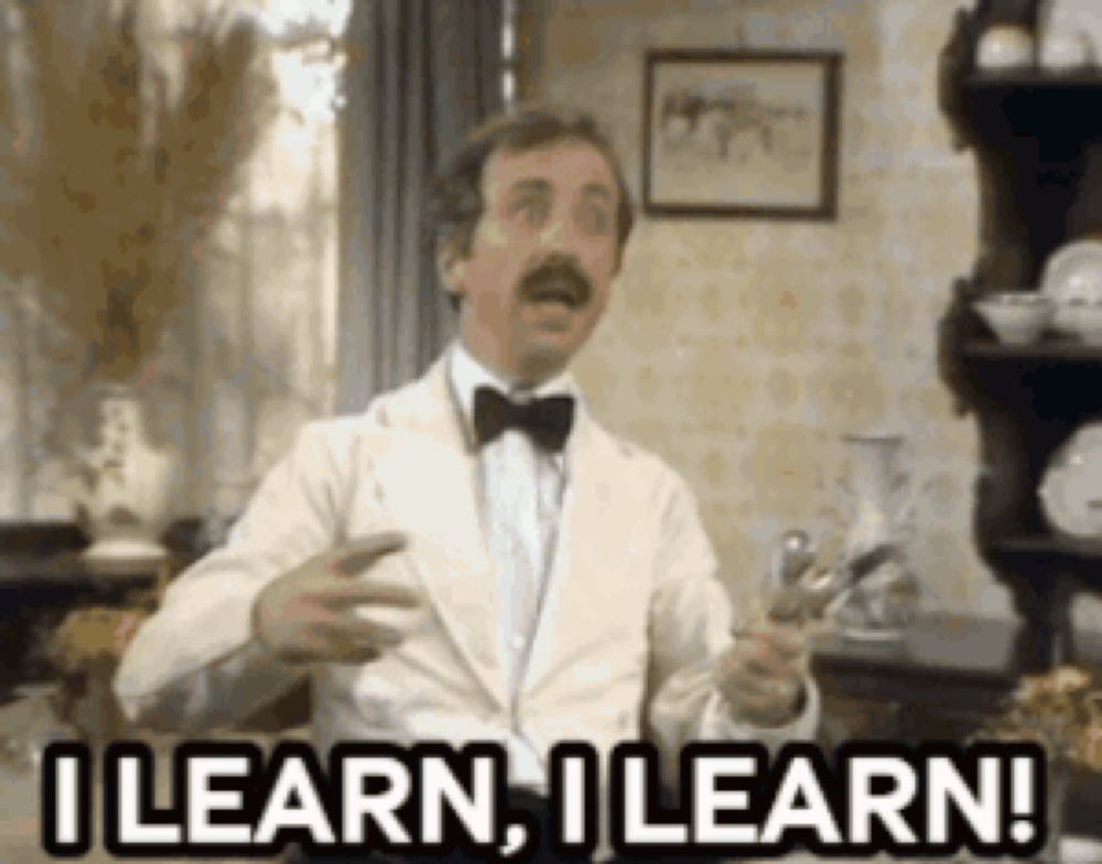 a man in a tuxedo and bow tie is holding a pair of scissors and saying i learn i learn !