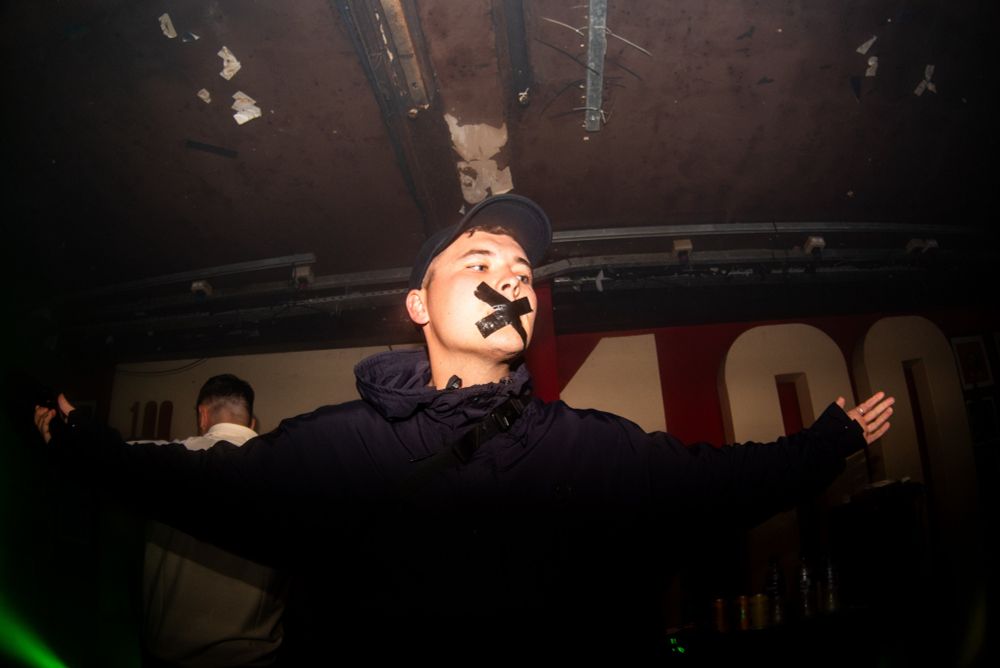 Mo Chara arrives on stage at the 100 Club in London with his mouth taped shut. 
