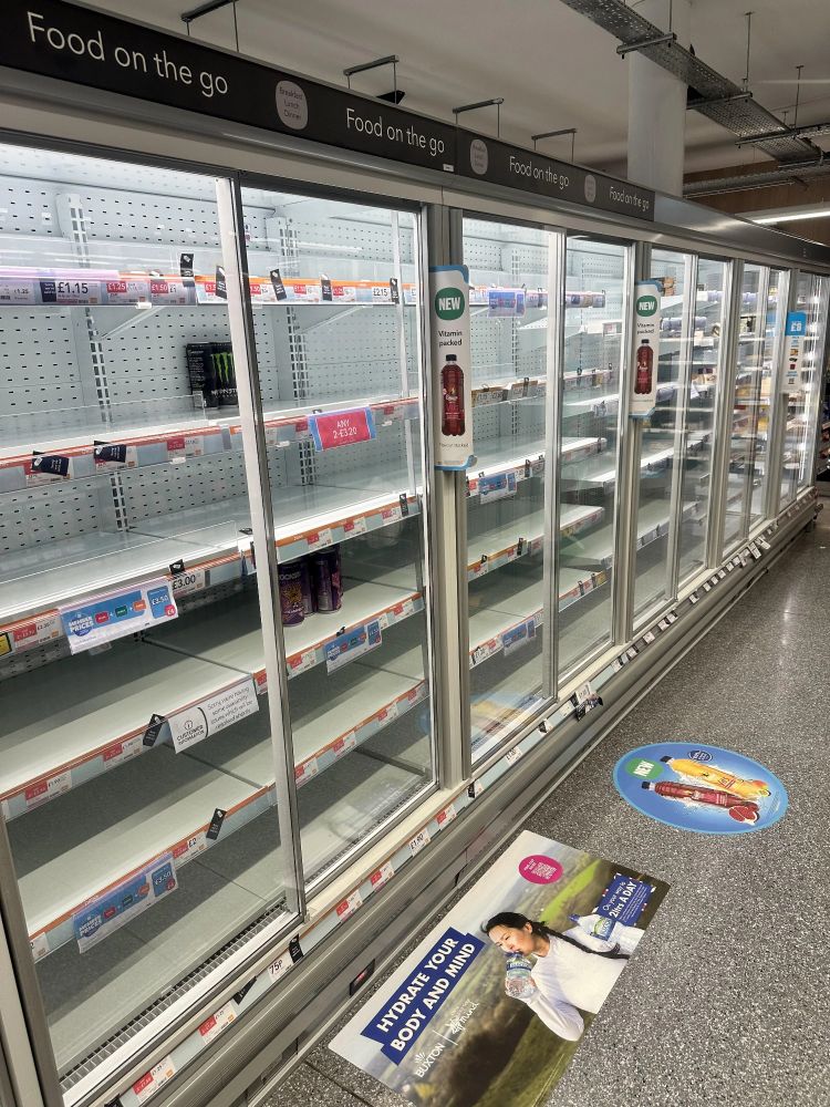 Photo showing empty shelves in a chiller in a UK Co-op store.