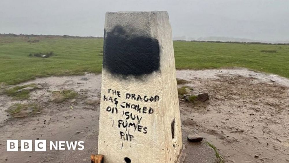 Garth Hill: Welsh dragon covered in graffiti on trig point