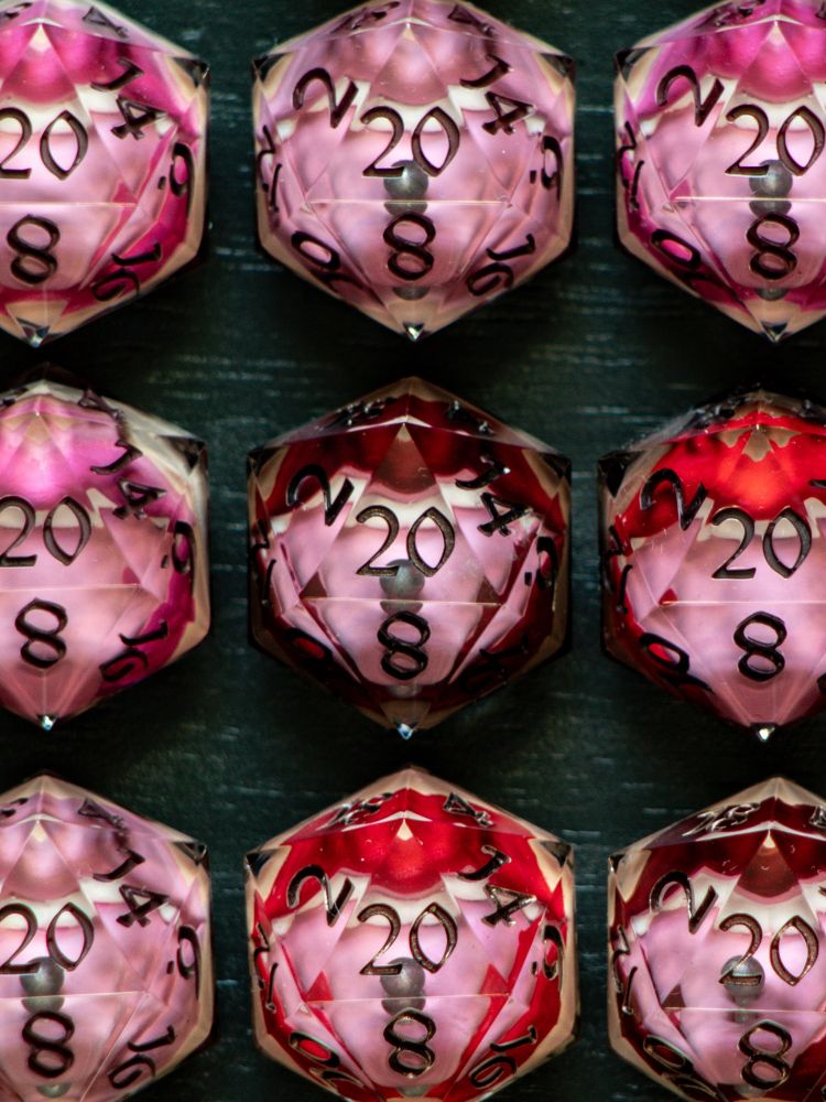 Handmade D20s with mouth mimic inclusions.