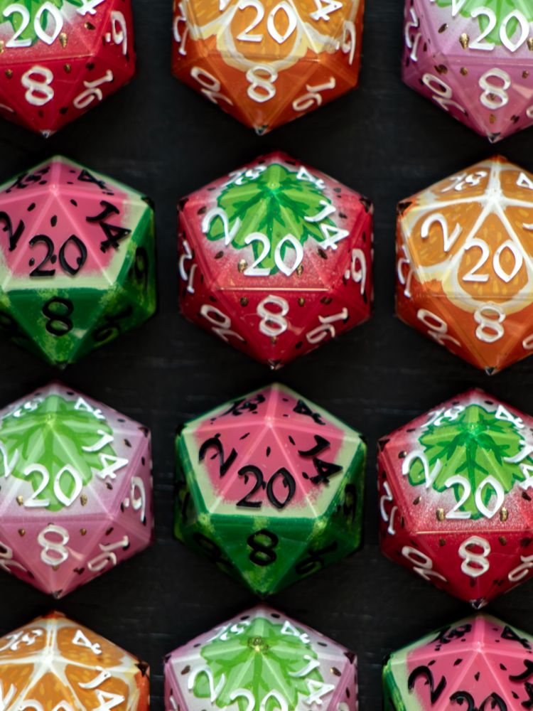 Handmade D20s painted to look like fruit.