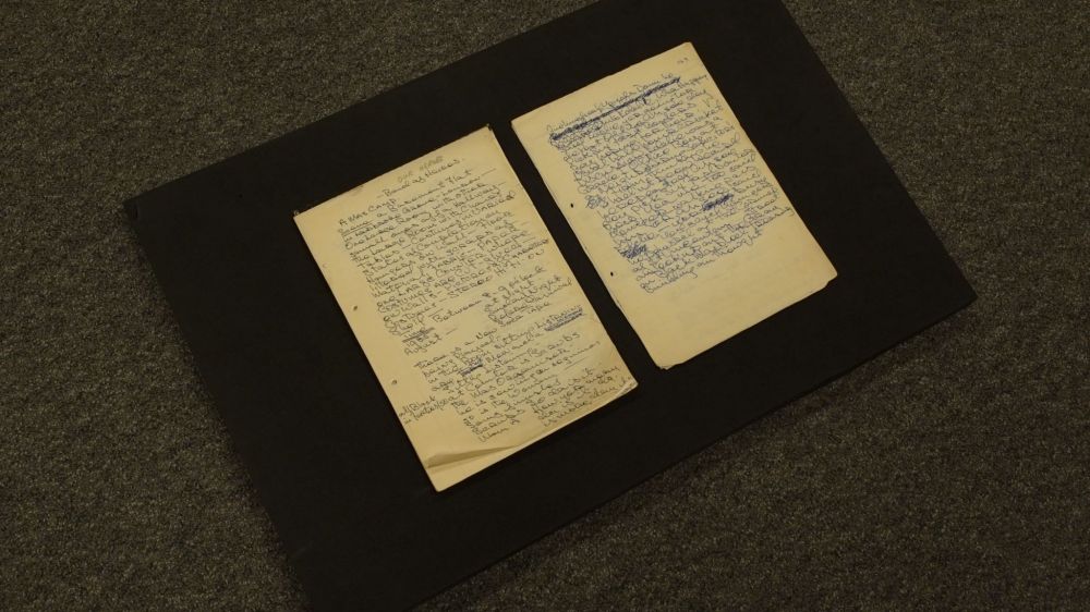 Archive of Mustapha Matura, showing a flat lay of two pages of a handwritten script.
