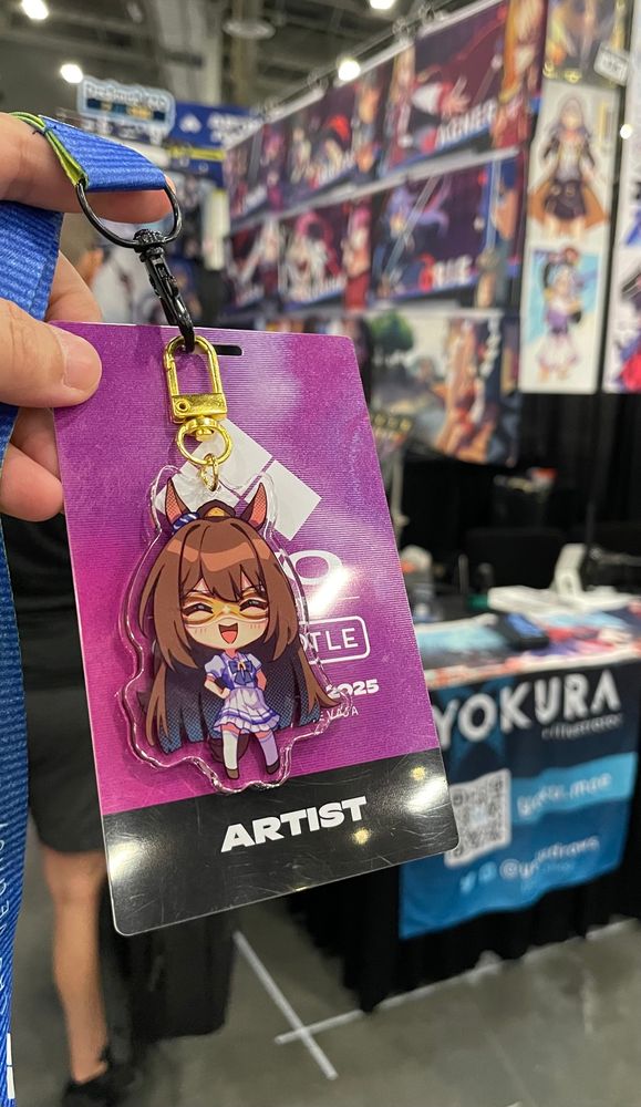 Photo of Evo artist badge with el condor pasa charm attached to it 
