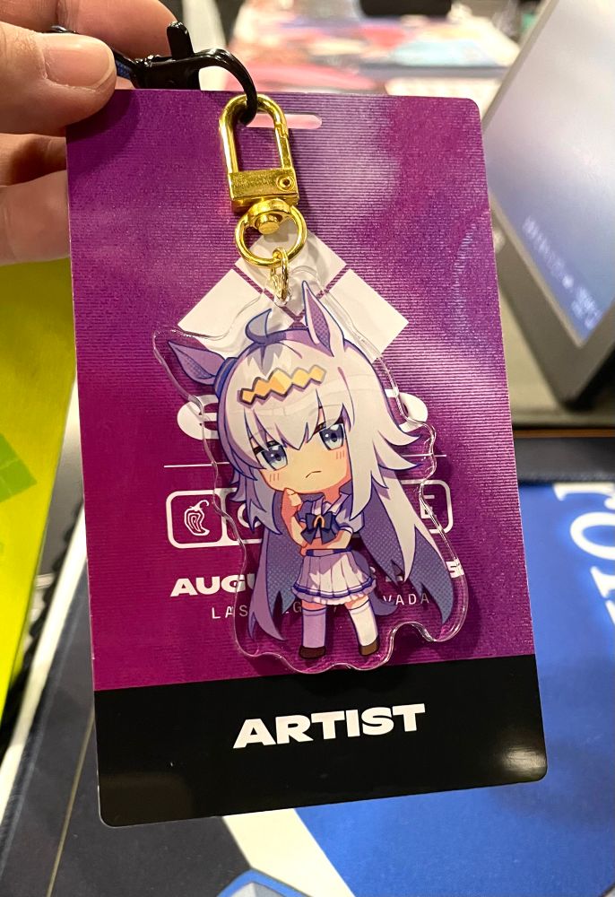 Photo of Evo artist badge with oguri cap charm hanging on it