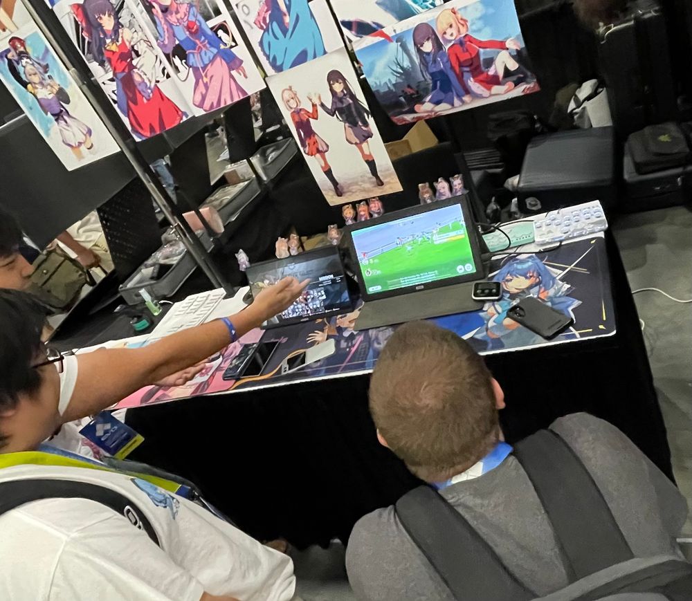 Photo of people gathered around table to watch umamusume custom races 