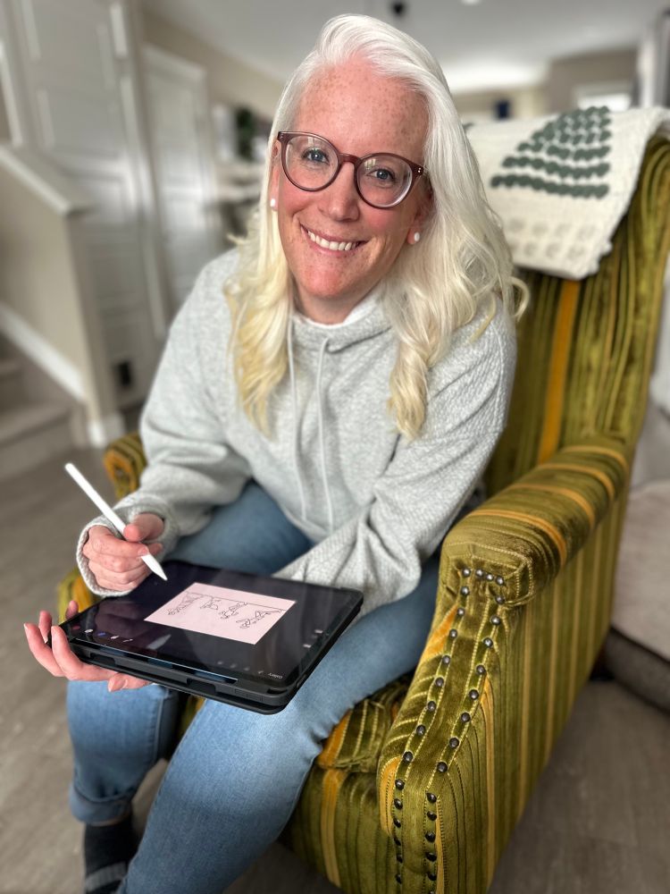 A person working with graphic design equipment, showcasing their logo as it comes to life on the screen.