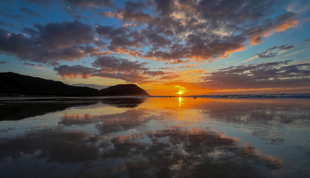 Sunrise on reflective beach