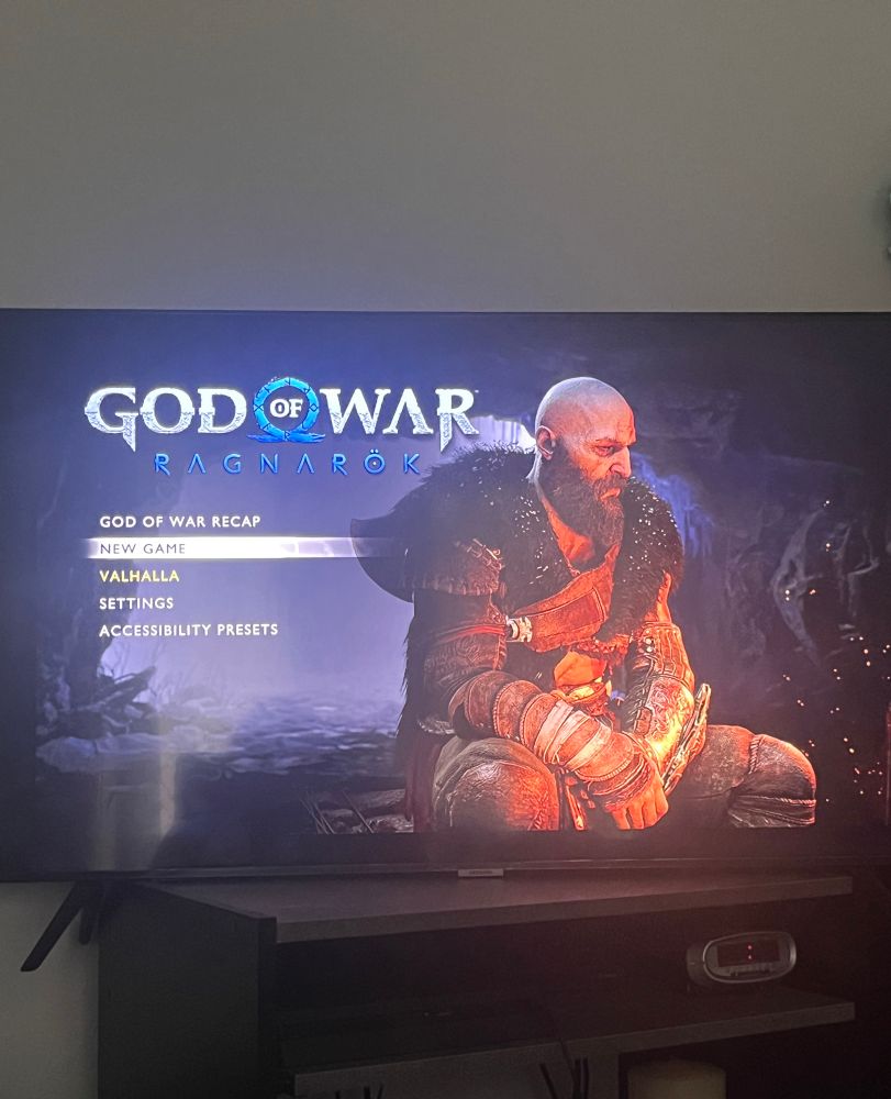 Photo of a television displaying the title screen for the video game God of War: Ragnarok