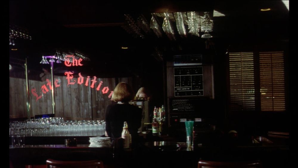 A woman working behind a bar