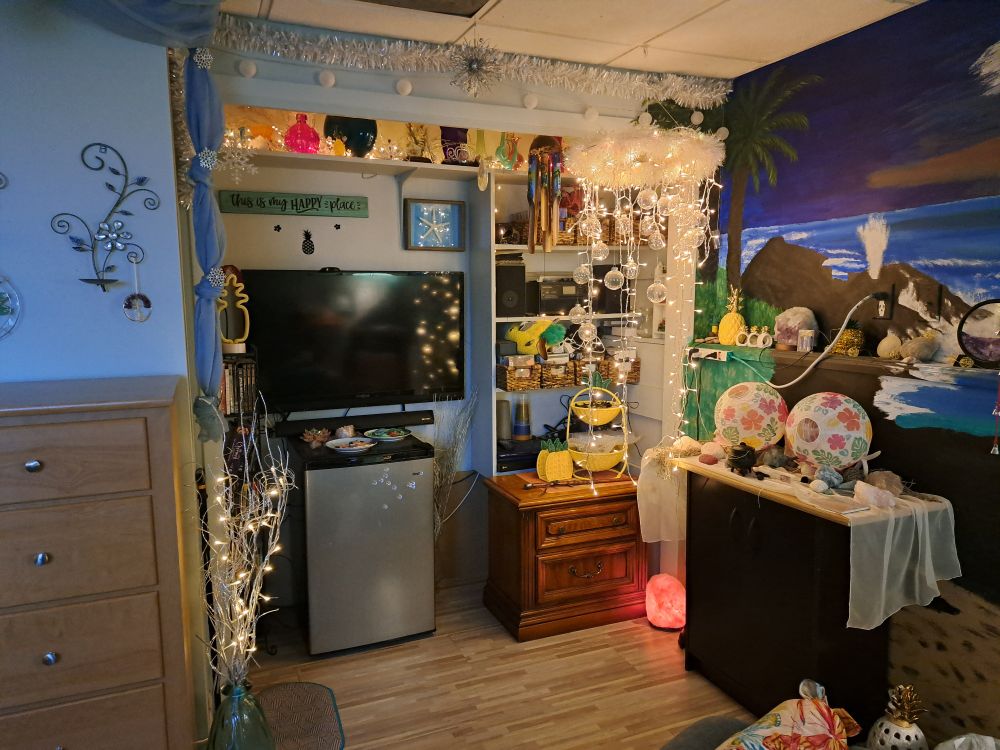 Entertainment area west wall of Pineapple Beach (TV, mini fridge, decor)